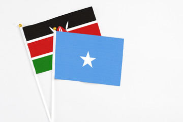 Somalia and Kenya stick flags on white background. High quality fabric, miniature national flag. Peaceful global concept.White floor for copy space.