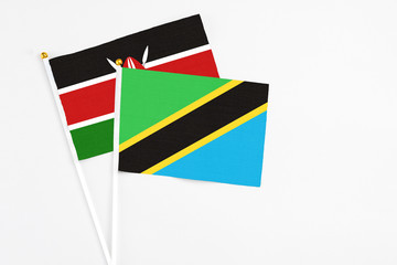Tanzania and Kenya stick flags on white background. High quality fabric, miniature national flag. Peaceful global concept.White floor for copy space.