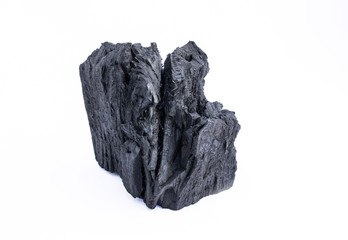 black coal on a white background. a porous black solid consisting of an amorphous form of carbon, obtained as a residue by heating wood, bone or other organic matter in the absence of air.