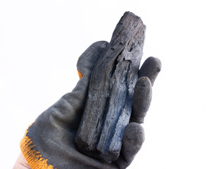 A miner's hand shows coal in a mine. The picture can be used to represent coal mining, an energy source, or environmental protection.