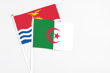 Algeria and Kiribati stick flags on white background. High quality fabric, miniature national flag....