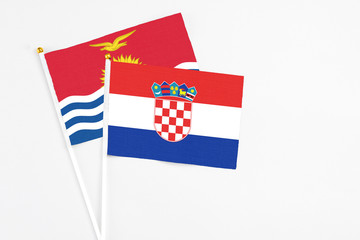 Croatia and Kiribati stick flags on white background. High quality fabric, miniature national flag. Peaceful global concept.White floor for copy space.