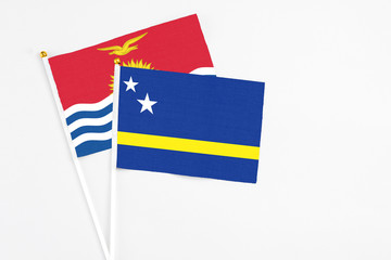 Curacao and Kiribati stick flags on white background. High quality fabric, miniature national flag. Peaceful global concept.White floor for copy space.