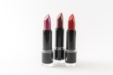 Three tones of lipstick isolated on white background.