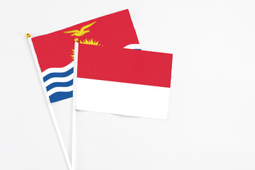 Indonesia and Kiribati stick flags on white background. High quality fabric, miniature national flag. Peaceful global concept.White floor for copy space.