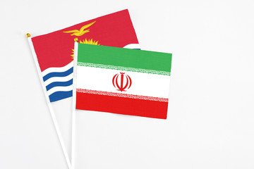 Iran and Kiribati stick flags on white background. High quality fabric, miniature national flag. Peaceful global concept.White floor for copy space.