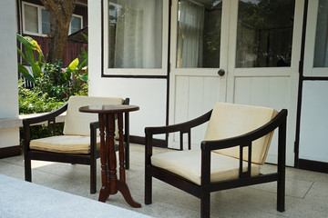 Exterior design and decoration of outdoor terrace and patio -decorated with vintage wooden armchair and table