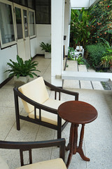 Fototapeta na wymiar Exterior design and decoration of outdoor terrace and patio -decorated with vintage wooden armchair and table
