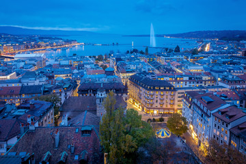 Aerial view of Geneva City center and Jet d'eau by night on World Diabetes Day.  This photo was taken shortly after sunset, at the blue hour, from the top of the tower of St. Peter's Cathedral. 