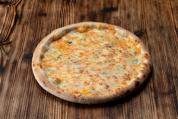 Hot four cheese pizza with melted mozzarella, cheddar, parmesan and blue cheese