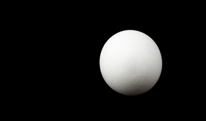 round white egg isolated on black background