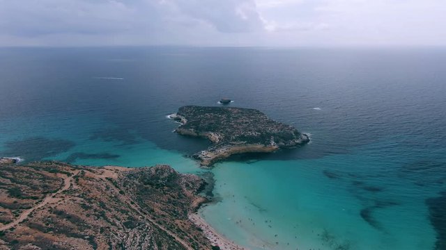 Aerial sliding view fo the famous beach isola dei conigli in Lampedusa, Italy
