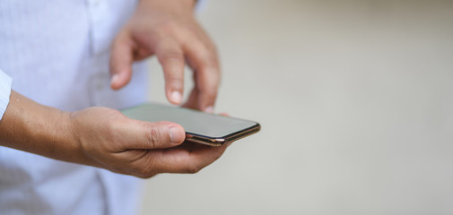 Cropped shot of man holding blank screen smartphone