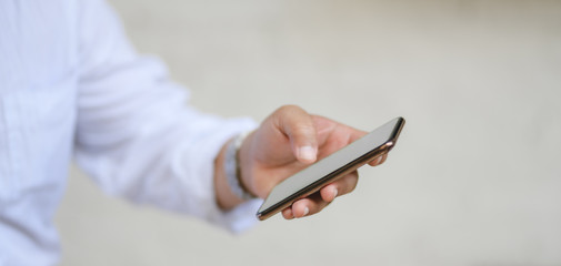Cropped shot of man holding blank screen smartphone