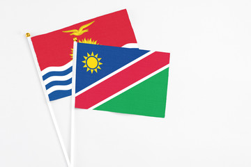 Namibia and Kiribati stick flags on white background. High quality fabric, miniature national flag. Peaceful global concept.White floor for copy space.