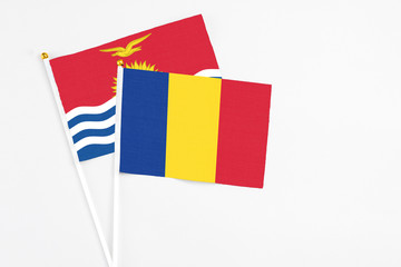 Romania and Kiribati stick flags on white background. High quality fabric, miniature national flag. Peaceful global concept.White floor for copy space.