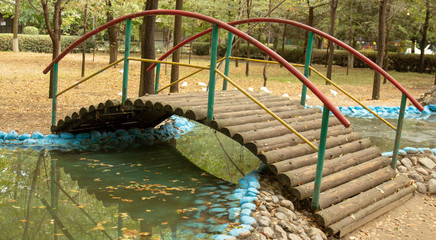 wooden bridge over a circular stream of water