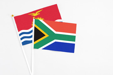 South Africa and Kiribati stick flags on white background. High quality fabric, miniature national flag. Peaceful global concept.White floor for copy space.