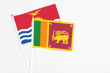 Sri Lanka and Kiribati stick flags on white background. High quality fabric, miniature national flag. Peaceful global concept.White floor for copy space.