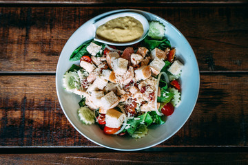 Close up Healthy food, Fresh Italian salad with Cucumber, bread, Tomato and green Vegetables on the wooden table for diet