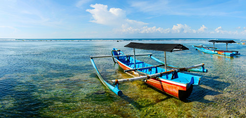  boat on white sand beach in bali -indonesia