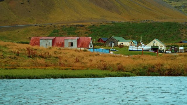 The small village of Hellnar across a lake, West Iceland