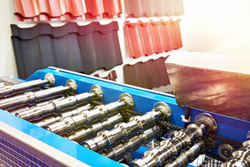 Machine for bending metal profile sheets