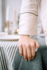 Close up of woman finger showing engagement ring with hands on her boyfriend's arms