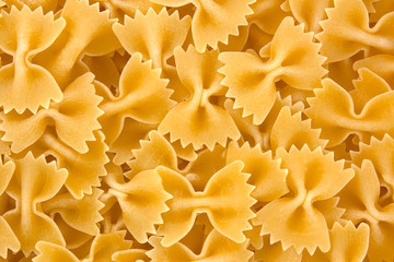 Farfalle - bow shaped pasta background.