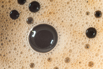 Air bubble foam formed on freshly flavored black coffee.