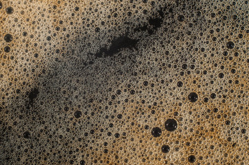 Air bubble foam formed on freshly flavored black coffee.