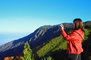 woman with binoculars in mountains