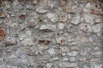 The texture of the gray stone wall