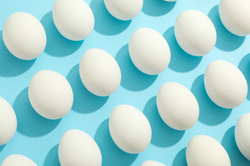 Flat lay composition with chicken eggs on color background, space for text