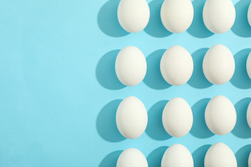 Flat lay composition with chicken eggs on color background, space for text