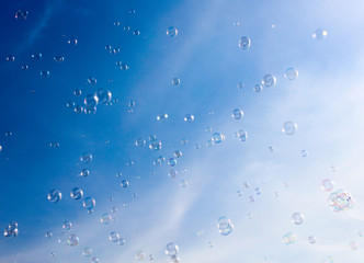 Soap bubbles fly in the blue sky