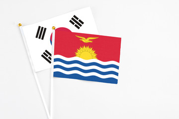 Kiribati and South Korea stick flags on white background. High quality fabric, miniature national flag. Peaceful global concept.White floor for copy space.