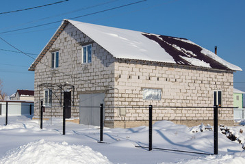 Brick house with snow on the roof