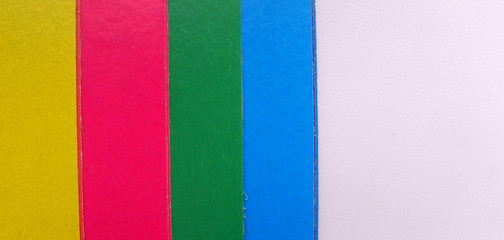 Children colored paper on a white background, located on the side, with space for text