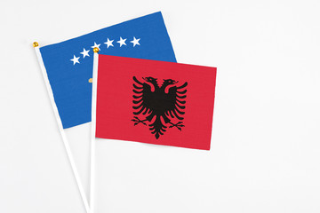 Albania and Kosovo stick flags on white background. High quality fabric, miniature national flag. Peaceful global concept.White floor for copy space.