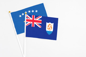Fototapeta premium Anguilla and Kosovo stick flags on white background. High quality fabric, miniature national flag. Peaceful global concept.White floor for copy space.