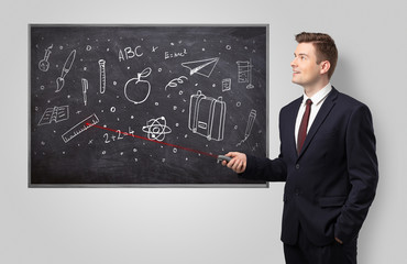 Handsome young teacher with laser pointer teaching