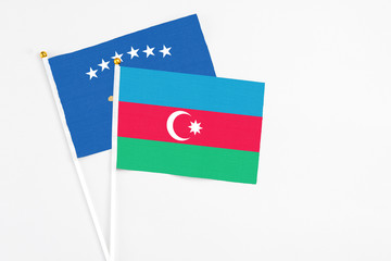 Azerbaijan and Kosovo stick flags on white background. High quality fabric, miniature national flag. Peaceful global concept.White floor for copy space.