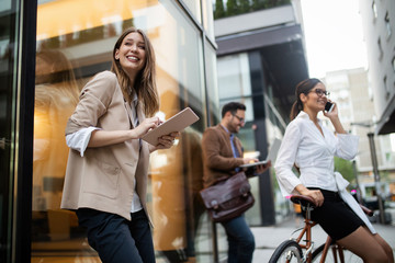 Happy business colleagues talking and walking in the city outdoor