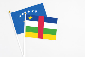 Central African Republic and Kosovo stick flags on white background. High quality fabric, miniature national flag. Peaceful global concept.White floor for copy space.