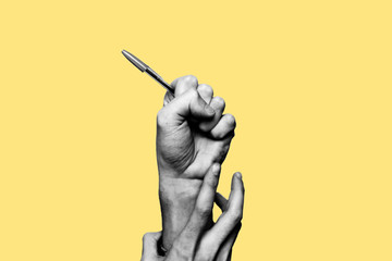 Concept of freedom of speech and information, stop censorship. Hand holding an open pen. It is dragged down by another hand. Black and white subject with a yellow background - obrazy, fototapety, plakaty