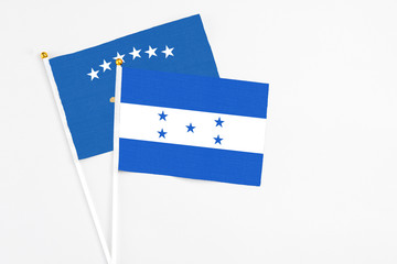 Honduras and Kosovo stick flags on white background. High quality fabric, miniature national flag....