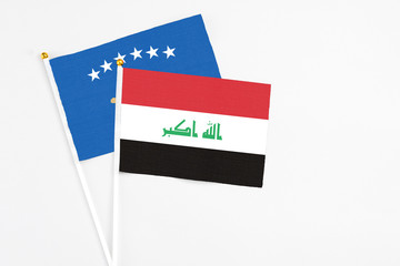 Iraq and Kosovo stick flags on white background. High quality fabric, miniature national flag. Peaceful global concept.White floor for copy space.