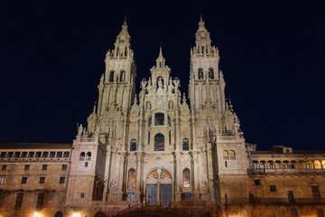Fototapeta premium Santiago de Compostela, Spain - 10/18/2018: Cathedral of Saint James with illumination on dark sky in Santiago de Compostela. Cathedral on Camino de Santiago in the night. 
