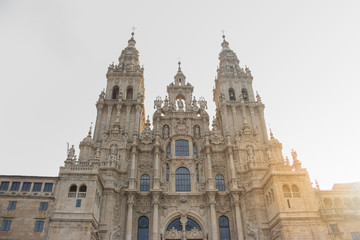 Fototapeta na wymiar Santiago de Compostela, Spain - 10/18/2018: Cathedral of Saint James with sun light in Santiago de Compostela, Spain. Famous cathedral on Camino de Santiago. Pilgrimage concept. 